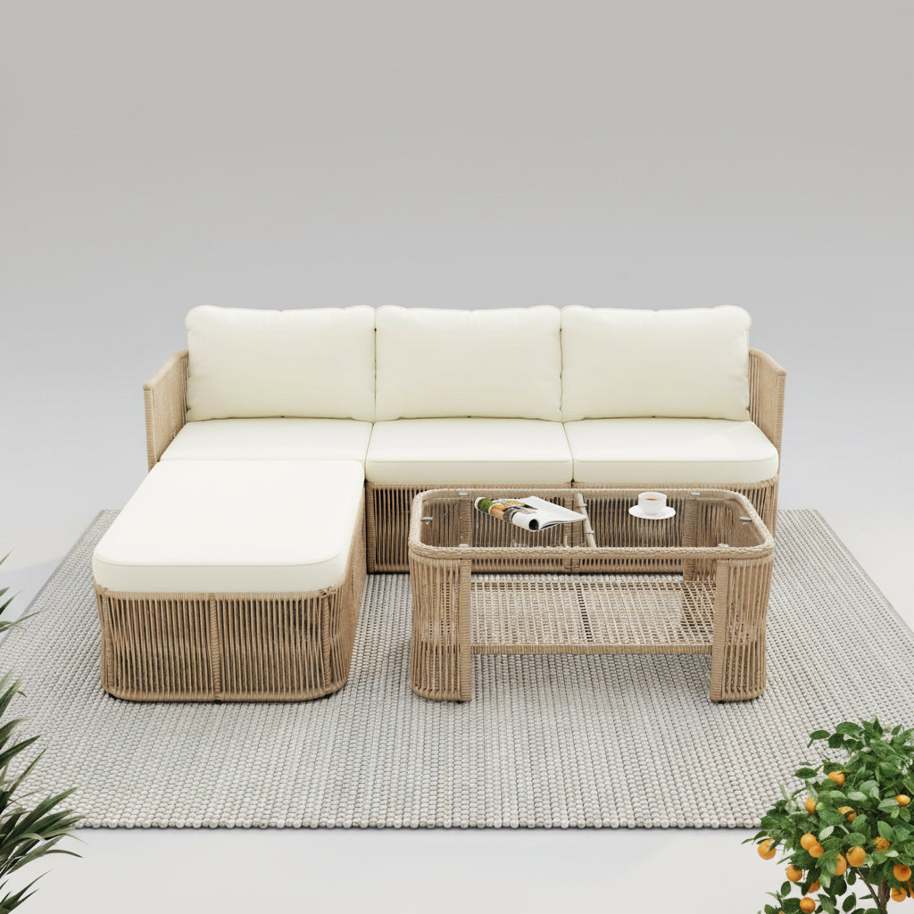 Outdoor patio set with sectional sofa and coffee table on a wooden deck, surrounded by greenery and flowers.