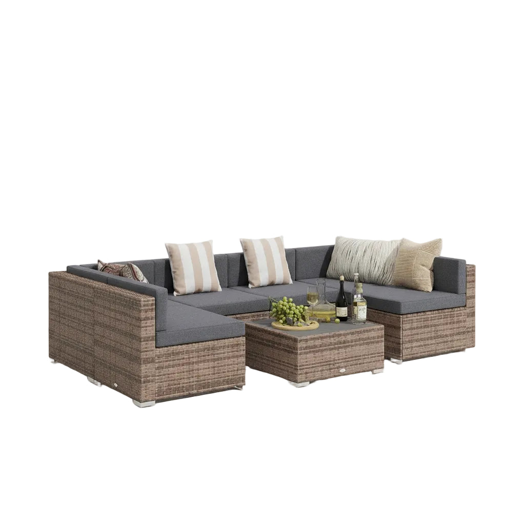 Outdoor patio set with cushions on a patio area with a wooden fence and house in the background.